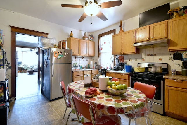 kitchen featuring appliances with stainless steel finishes, decorative backsplash, ceiling fan, and under cabinet range hood