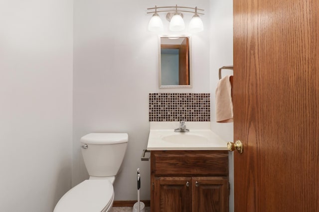 bathroom with toilet, tasteful backsplash, and vanity