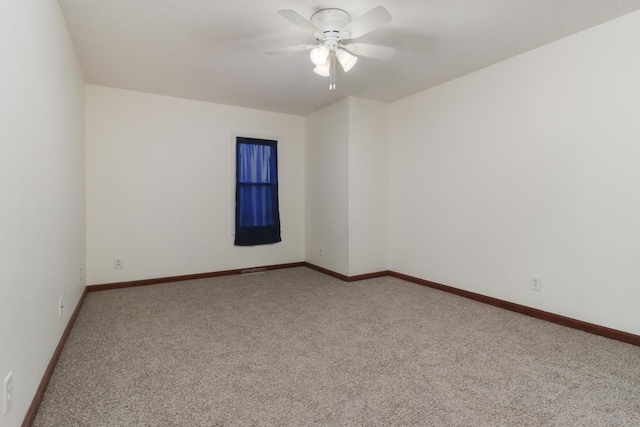 unfurnished room featuring baseboards, carpet flooring, and a ceiling fan