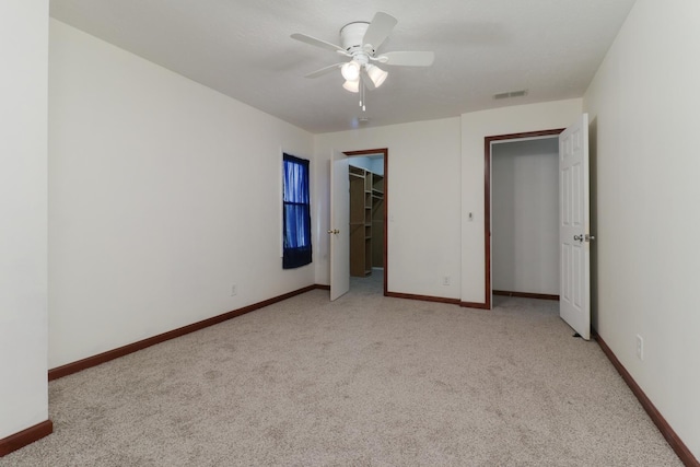 unfurnished bedroom featuring visible vents, baseboards, and light carpet