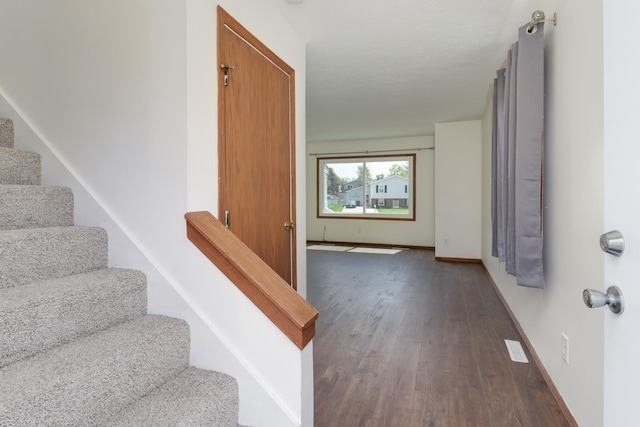 stairway with baseboards and wood finished floors