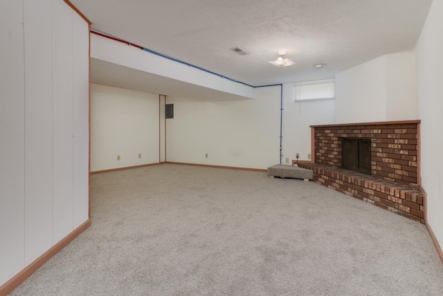 unfurnished living room with carpet flooring, baseboards, visible vents, and a fireplace