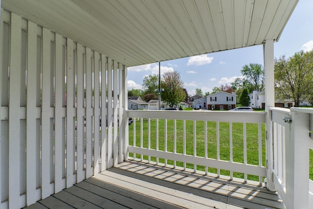 deck with a yard and a residential view