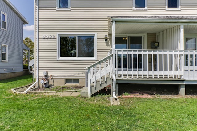 view of exterior entry with a lawn