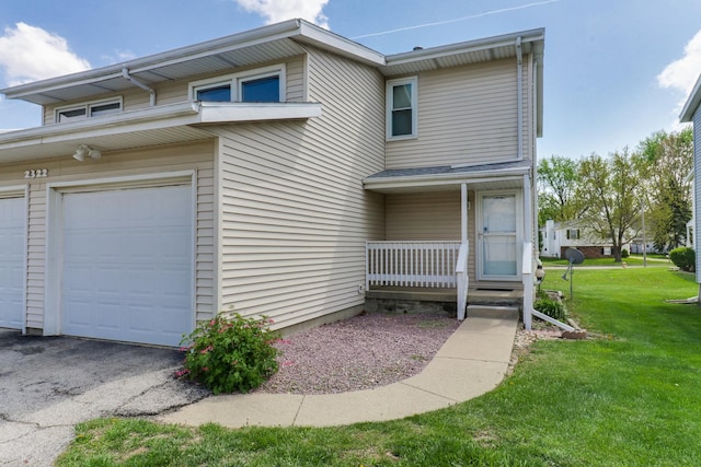 townhome / multi-family property featuring a porch, a front lawn, and a garage