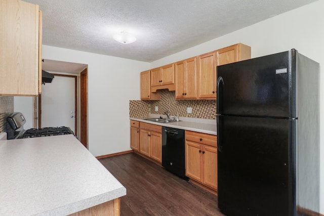 kitchen featuring light countertops, backsplash, and black appliances