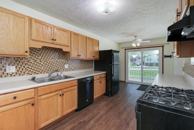 kitchen with a textured ceiling, a sink, light countertops, black appliances, and under cabinet range hood
