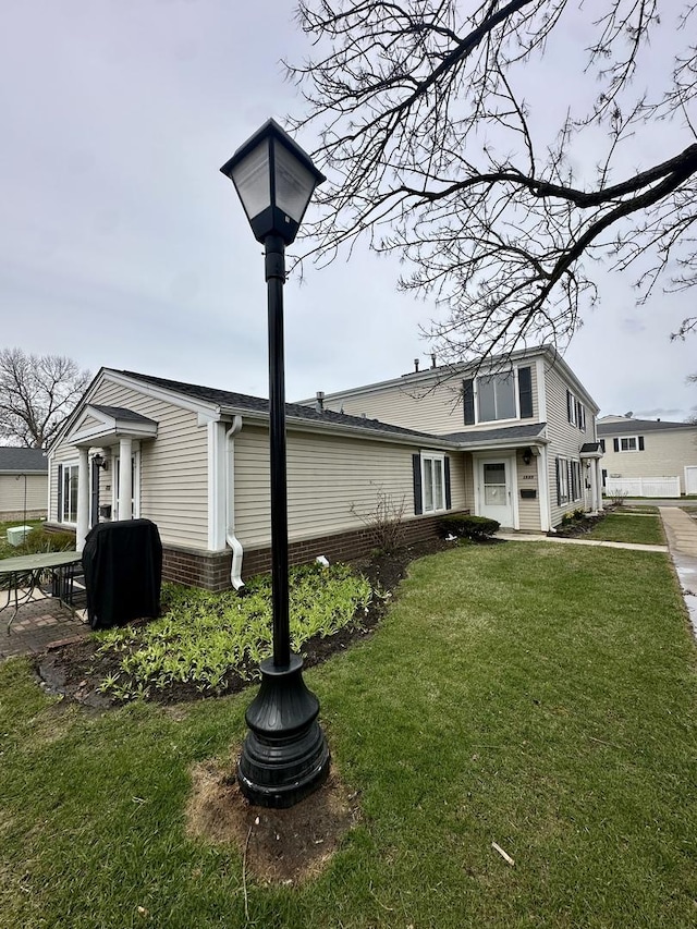 view of side of home with a lawn