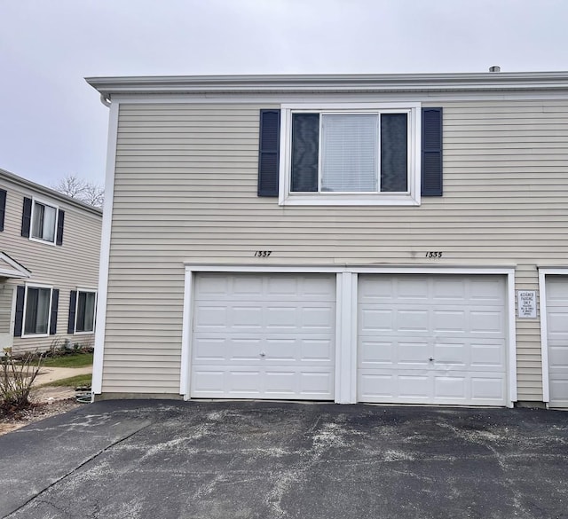 garage with aphalt driveway