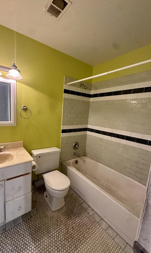 full bath with visible vents, toilet,  shower combination, vanity, and tile patterned flooring