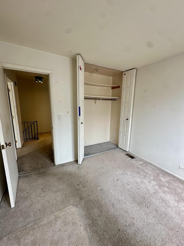 unfurnished bedroom with a closet and carpet
