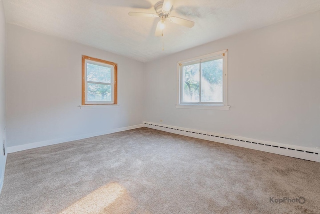 2051 E 72nd St Unit 1B, Chicago, IL 60649 - carpeted spare room featuring a baseboard heating unit, plenty of natural light, ceiling fan, and a textured ceiling