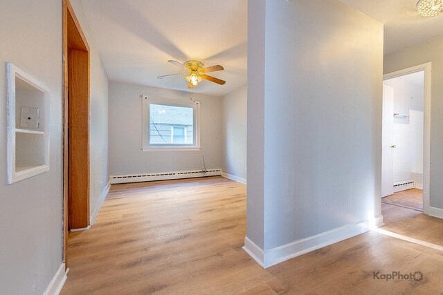 2051 E 72nd St Unit 1B, Chicago, IL 60649 - spare room with baseboard heating and wood finished floors