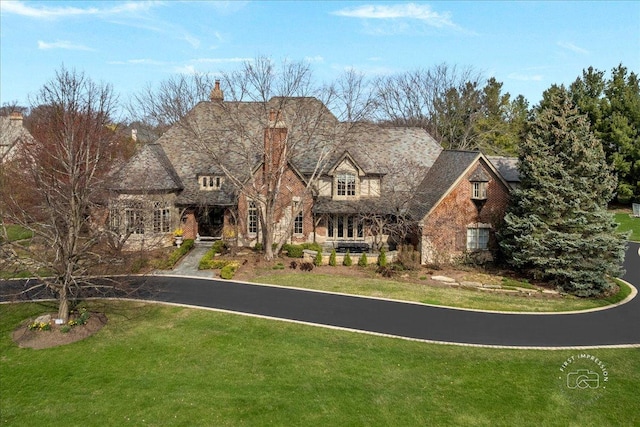36W442 Hunters Gate Rd, Saint Charles, IL 60175 - view of front of property featuring a front lawn, a chimney, and stone siding