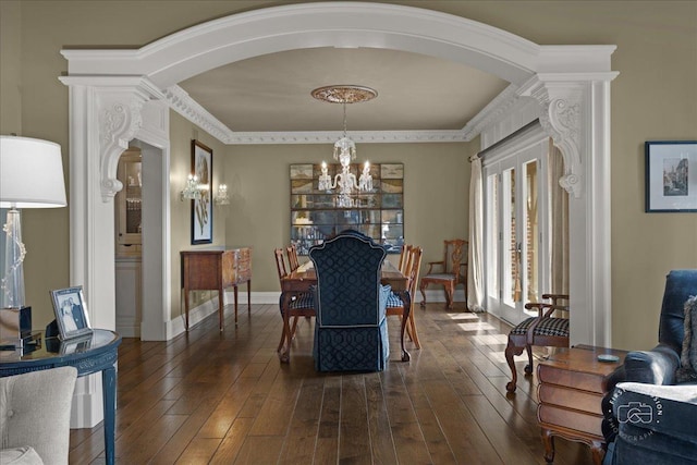 36W442 Hunters Gate Rd, Saint Charles, IL 60175 - dining space featuring arched walkways, a chandelier, dark wood-style flooring, baseboards, and decorative columns