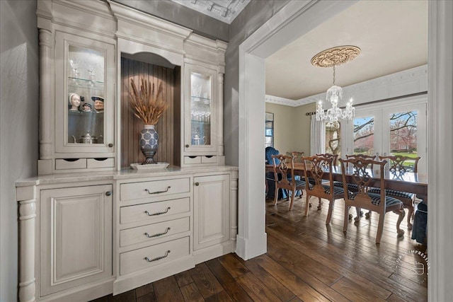 36W442 Hunters Gate Rd, Saint Charles, IL 60175 - bar area with a chandelier, dark wood-type flooring, healthy amount of natural light, hanging light fixtures, and ornamental molding
