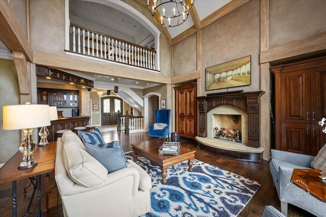 36W442 Hunters Gate Rd, Saint Charles, IL 60175 - living area featuring arched walkways, a chandelier, hardwood / wood-style flooring, a high ceiling, and baseboards