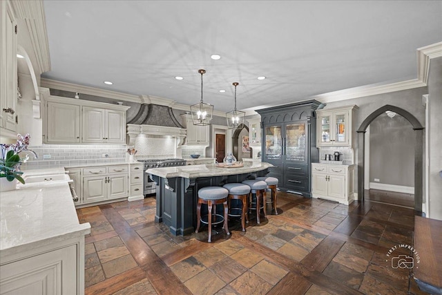 36W442 Hunters Gate Rd, Saint Charles, IL 60175 - kitchen featuring a sink, custom exhaust hood, stainless steel stove, a center island, and tasteful backsplash