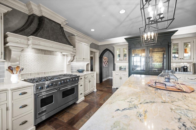 36W442 Hunters Gate Rd, Saint Charles, IL 60175 - kitchen featuring double oven range, a chandelier, glass insert cabinets, light stone countertops, and recessed lighting