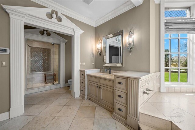 36W442 Hunters Gate Rd, Saint Charles, IL 60175 - bathroom featuring a stall shower, toilet, vanity, crown molding, and baseboards