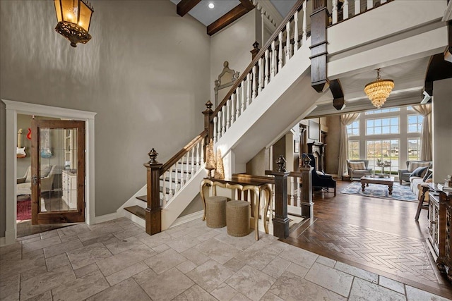 36W442 Hunters Gate Rd, Saint Charles, IL 60175 - staircase featuring stone tile flooring, a high ceiling, baseboards, and beamed ceiling