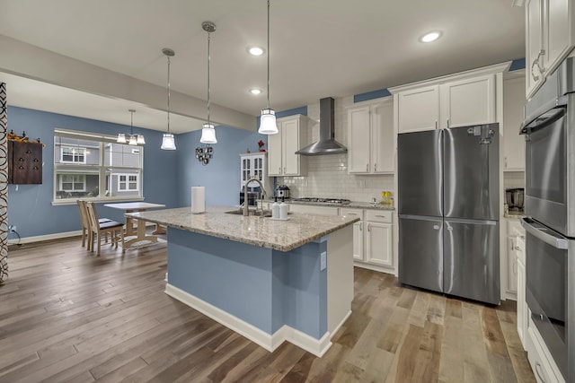 34 Commons Cir, Hawthorn Woods, IL 60047 - kitchen featuring wall chimney range hood, a sink, stainless steel appliances, white cabinetry, and decorative backsplash