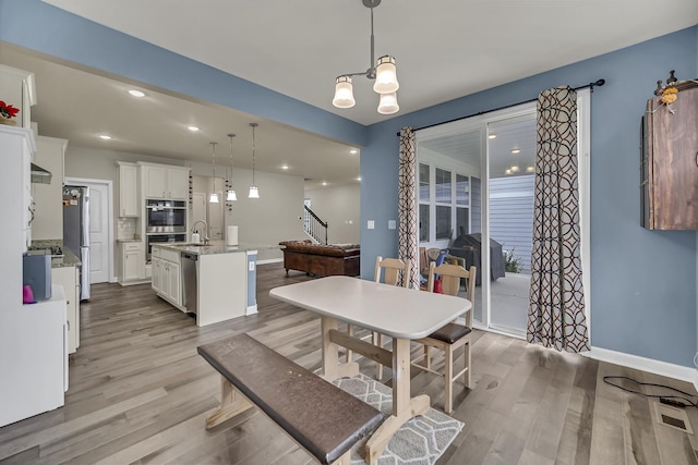 34 Commons Cir, Hawthorn Woods, IL 60047 - dining area with light wood-style floors, baseboards, recessed lighting, and stairs