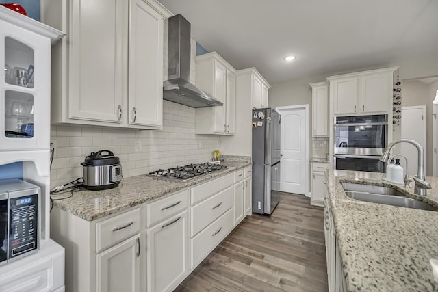 34 Commons Cir, Hawthorn Woods, IL 60047 - kitchen with wall chimney range hood, white cabinets, a sink, stainless steel appliances, and dark wood-type flooring