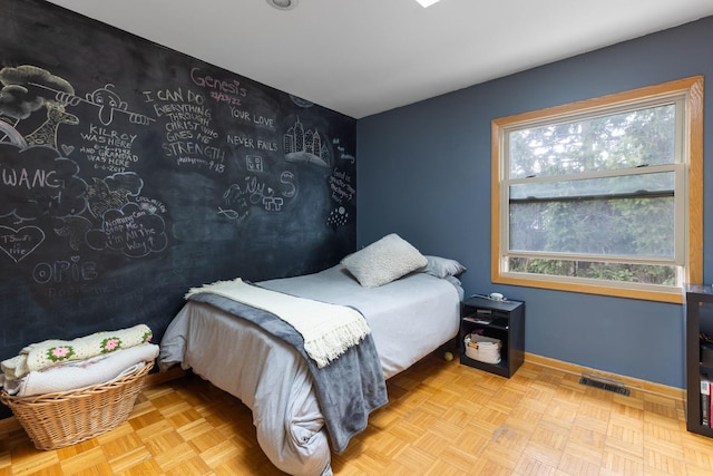 bedroom featuring visible vents and baseboards