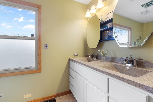 full bath featuring a sink, tile patterned floors, double vanity, and baseboards