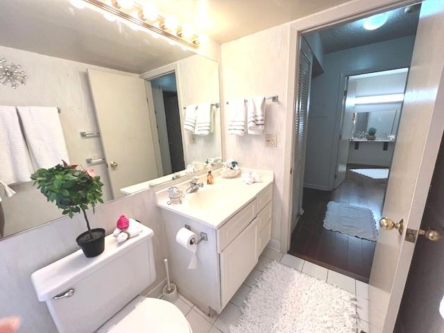 bathroom featuring tile patterned floors, toilet, and vanity