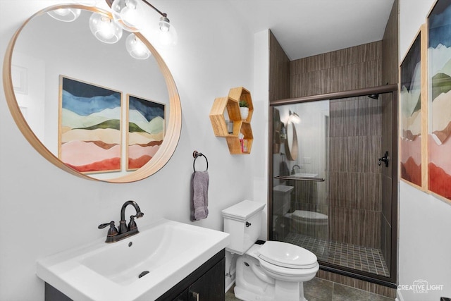 full bath featuring toilet, a stall shower, vanity, and tile patterned flooring
