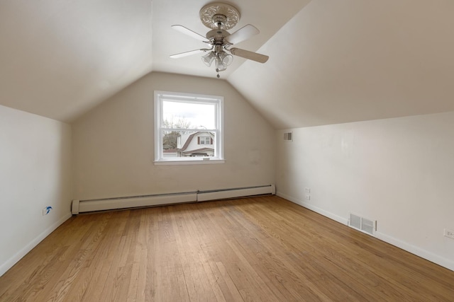 bonus room featuring a baseboard heating unit, vaulted ceiling, visible vents, a ceiling fan, and wood finished floors