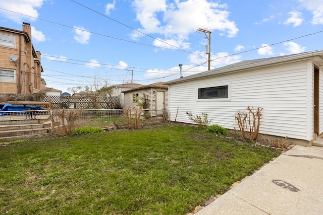 view of home's exterior with fence and a yard