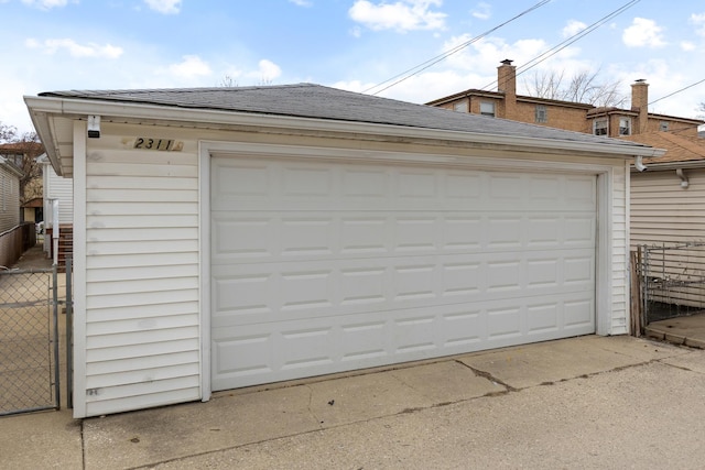 detached garage featuring fence