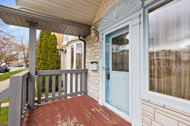wooden terrace featuring covered porch