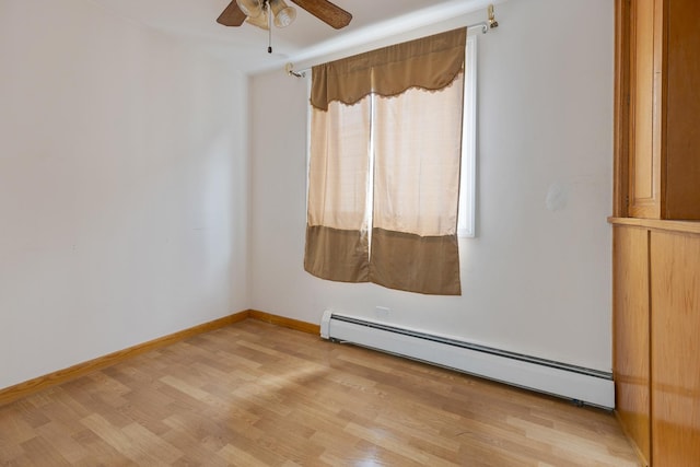 unfurnished room with light wood finished floors, ceiling fan, baseboards, and a baseboard radiator