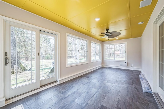 unfurnished sunroom with baseboards, visible vents, and recessed lighting