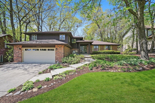 view of front facade with brick siding, driveway, and a front lawn