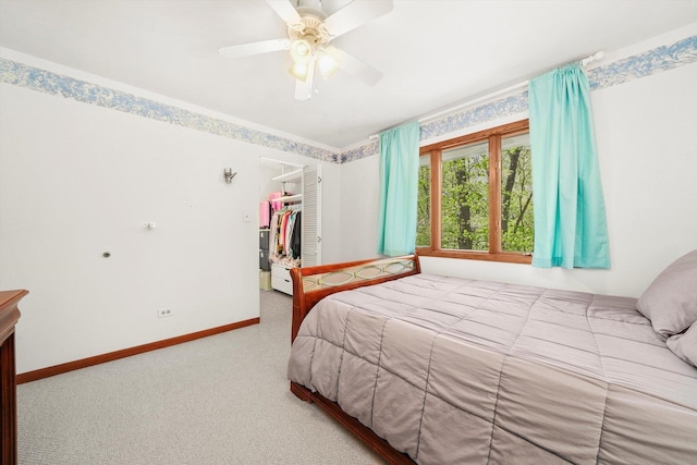 carpeted bedroom with baseboards, a closet, a spacious closet, and ceiling fan