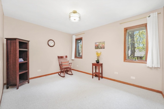 sitting room featuring carpet floors and baseboards