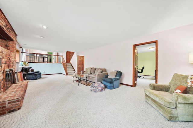 living room featuring carpet, baseboards, stairway, and a brick fireplace