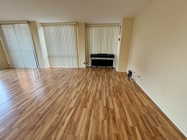 345 W Fullerton Pkwy Unit 503, Chicago, IL 60614 - unfurnished living room featuring radiator, wood finished floors, and a fireplace