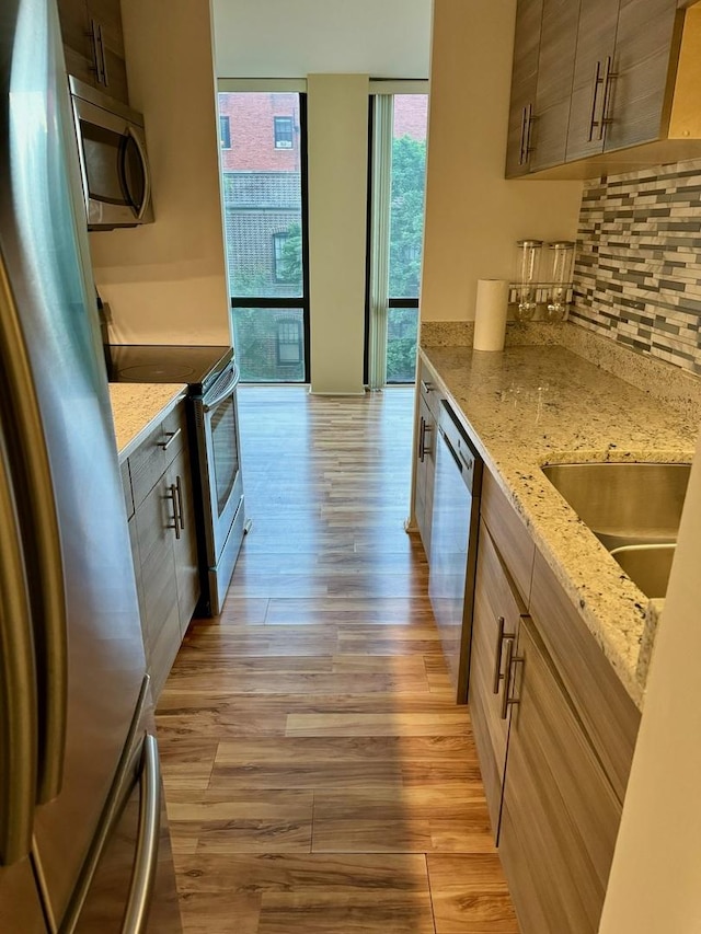 345 W Fullerton Pkwy Unit 503, Chicago, IL 60614 - kitchen with light wood-style flooring, tasteful backsplash, floor to ceiling windows, appliances with stainless steel finishes, and a sink