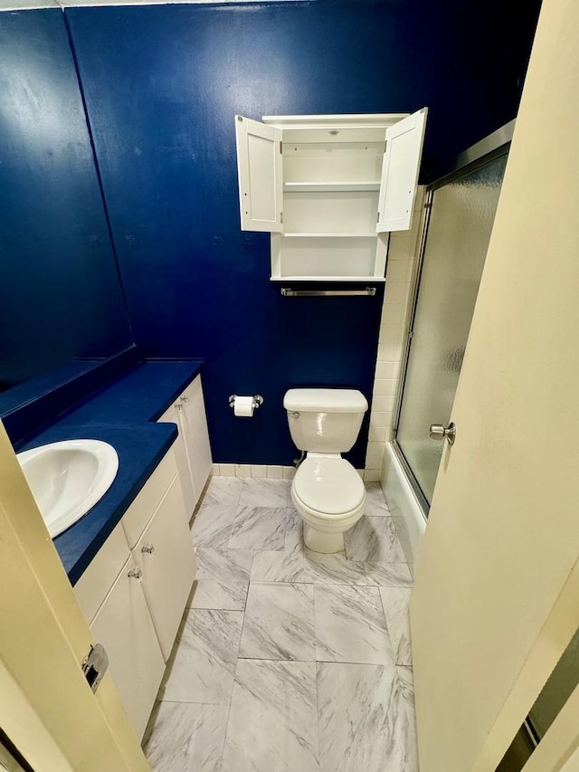 345 W Fullerton Pkwy Unit 503, Chicago, IL 60614 - full bath with baseboards, combined bath / shower with glass door, toilet, vanity, and marble finish floor