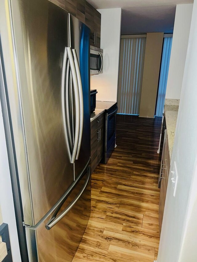 345 W Fullerton Pkwy Unit 503, Chicago, IL 60614 - kitchen with appliances with stainless steel finishes, wood finished floors, modern cabinets, and dark brown cabinetry