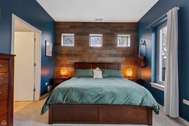 3920 N Sheridan Rd Unit 304, Chicago, IL 60613 - carpeted bedroom featuring wooden walls, an accent wall, and visible vents