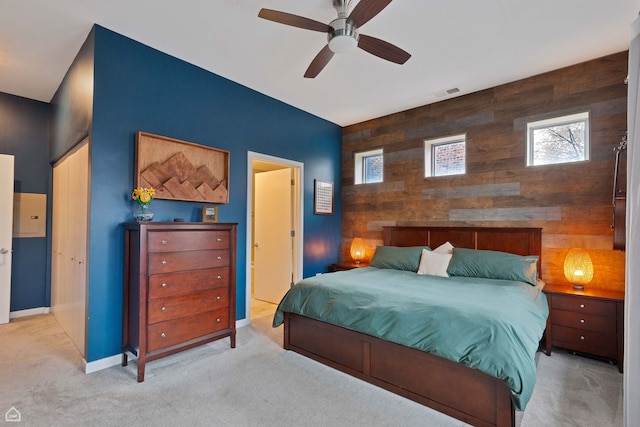 3920 N Sheridan Rd Unit 304, Chicago, IL 60613 - carpeted bedroom with visible vents, baseboards, an accent wall, a ceiling fan, and wooden walls