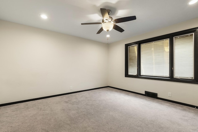 carpeted empty room with visible vents, a ceiling fan, baseboards, and recessed lighting