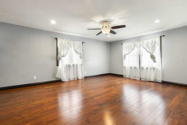 empty room featuring wood-type flooring, recessed lighting, a ceiling fan, and plenty of natural light